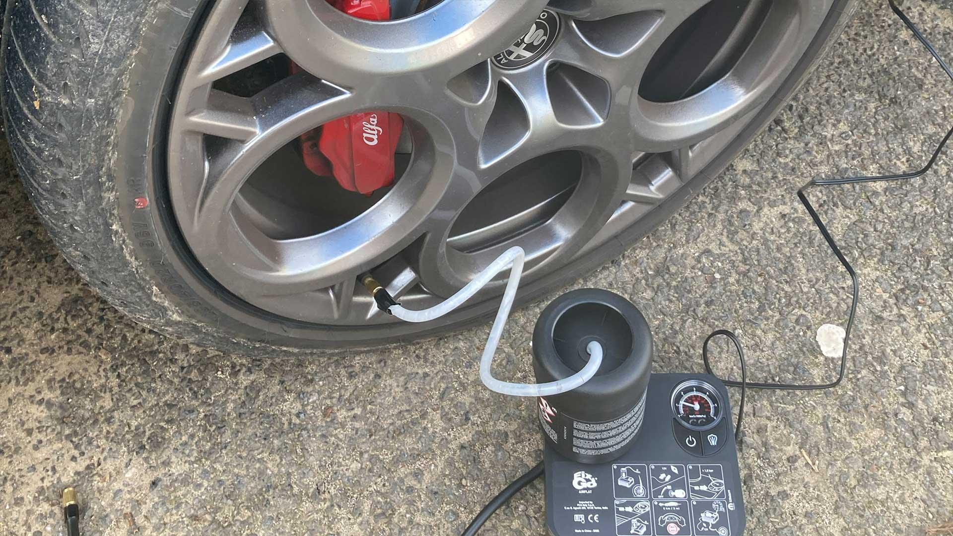 Repair kit for a flat tire in the back of a car