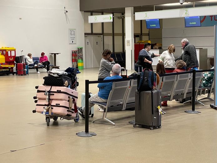 Some travelers stranded in Ostend wait in the hall to be picked up.