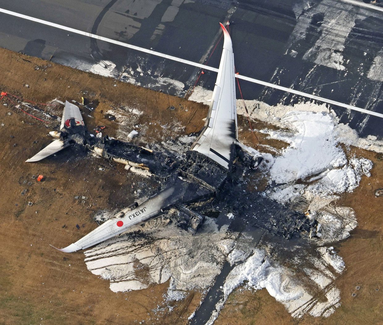 An aerial photo shows a burning Japan Airlines Airbus A350.  Image via Reuters