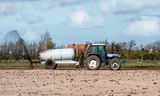 A farmer in Texel spreads manure.